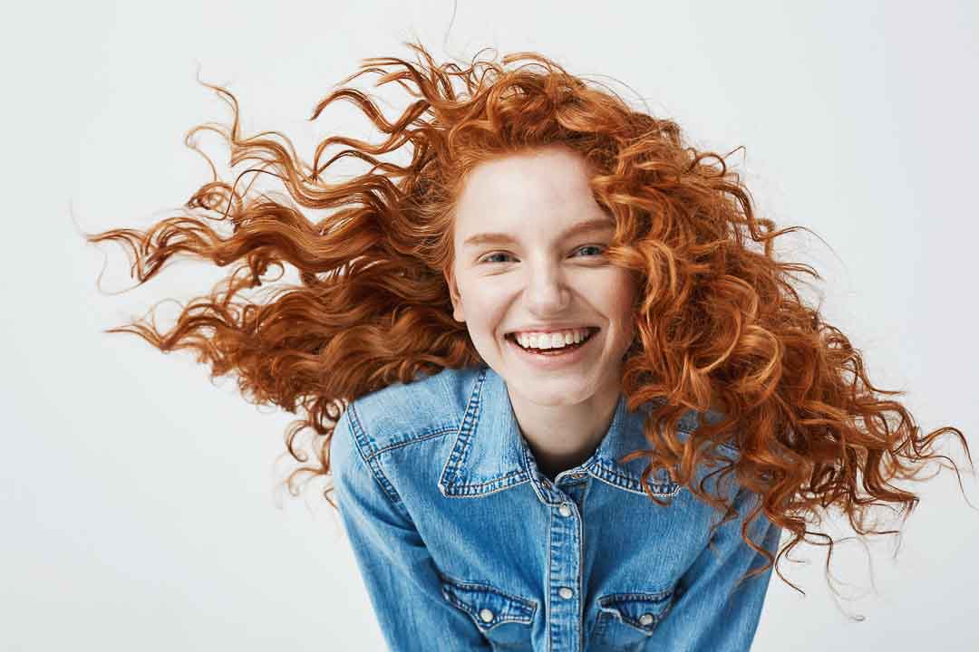 https://blaco.braincontentnetwork.net/media/08/1b/40/1699672633/portrait-of-beautiful-cheerful-redhead-woman-with-flying-curly-hair-smiling-laughing.jpg